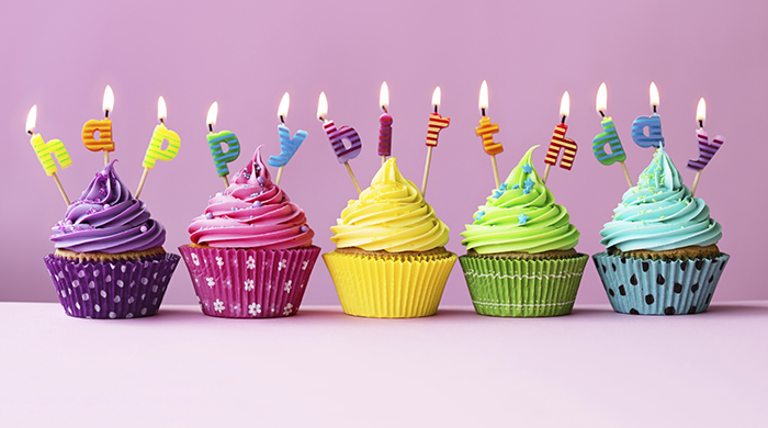Cupcakes with candles spelling the words "happy birthday"